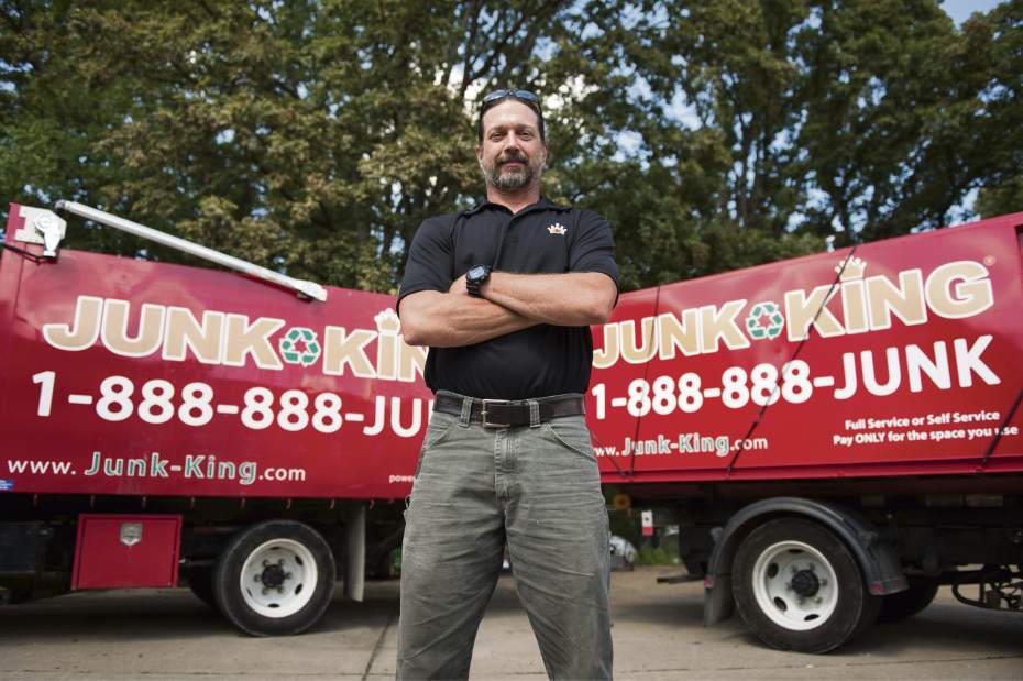 owner of the Holly Springs location standing in front of the junk removal truck